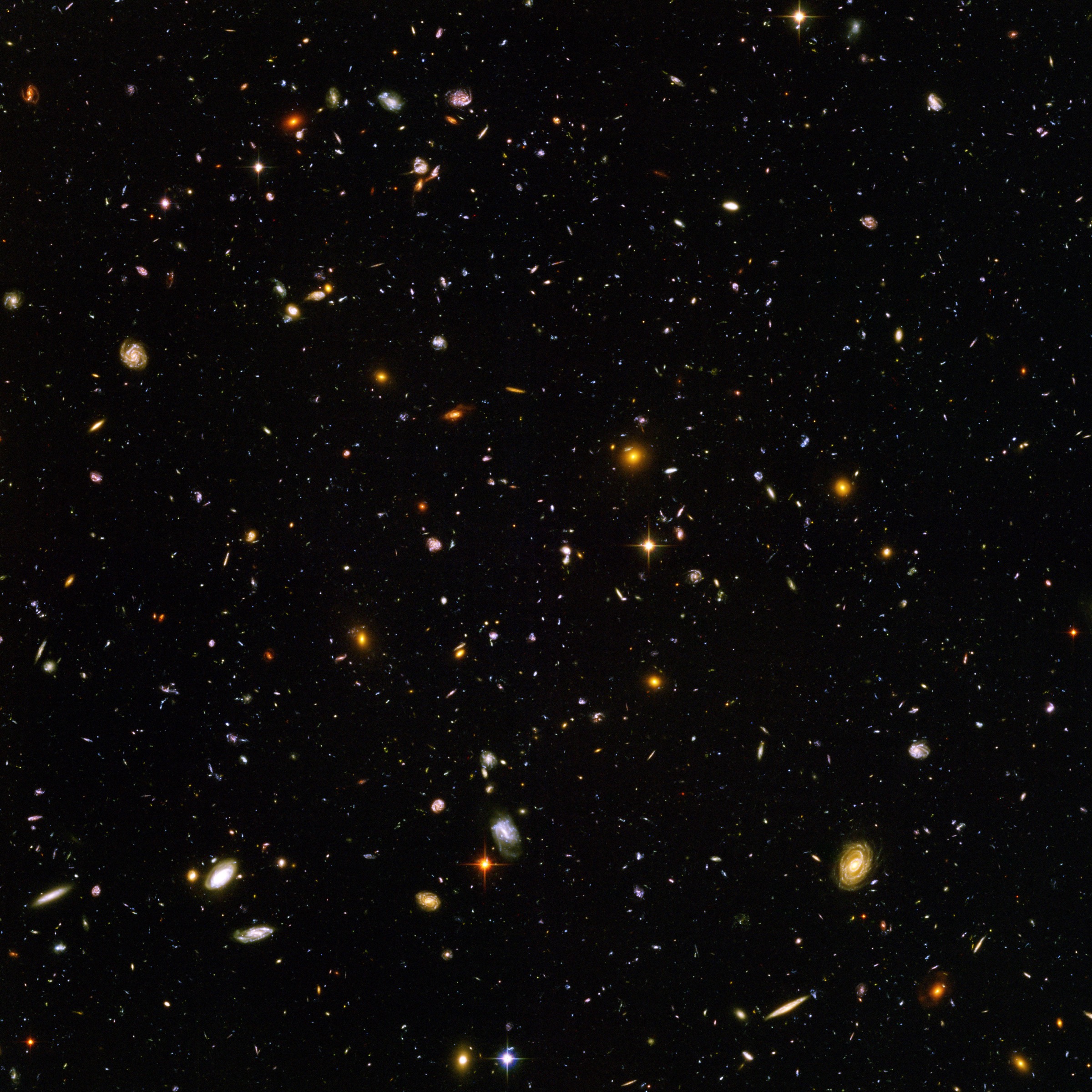 The Hubble Ultra Deep Field, a dark field of space filled with thousands of distant galaxies.