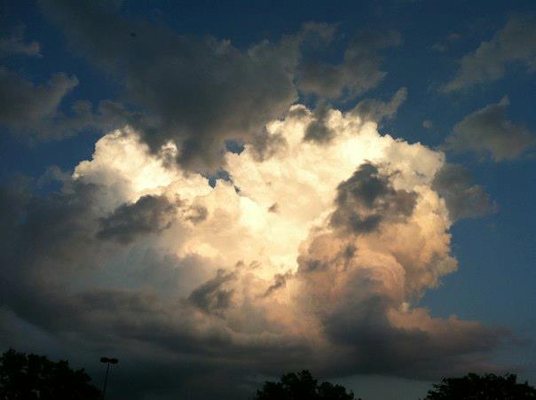 A glowing storm cloud against a dark sky.